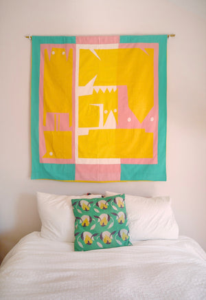 The flag is hanging on a wall above a bed.